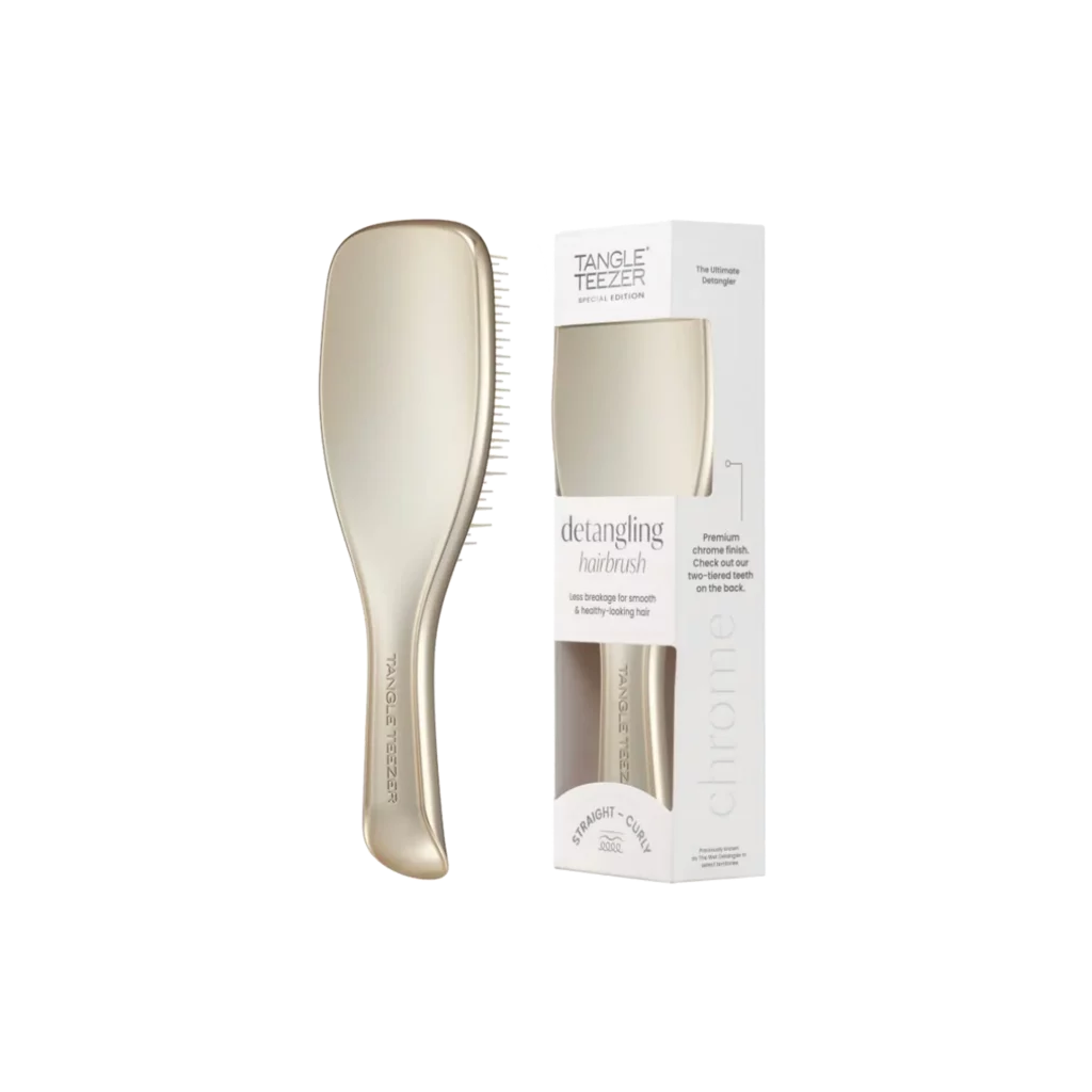Goudkleurige Tangle Teezer ontklittende haarborstel naast bijpassende verpakking.