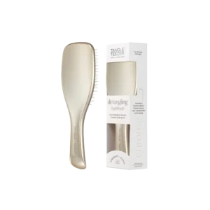Goudkleurige Tangle Teezer ontklittende haarborstel naast bijpassende verpakking.