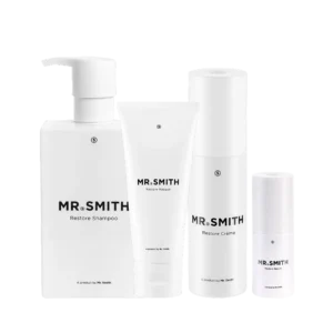 Vier witte haarverzorgingsproducten uit de "Mr. Smith The Ultimate Hair Restore Pack" met minimalistisch ontwerp.