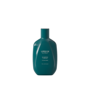 Donkergroene fles Urban Alchemy Moisture Mane shampoo met witte opdruk op een zwarte achtergrond.